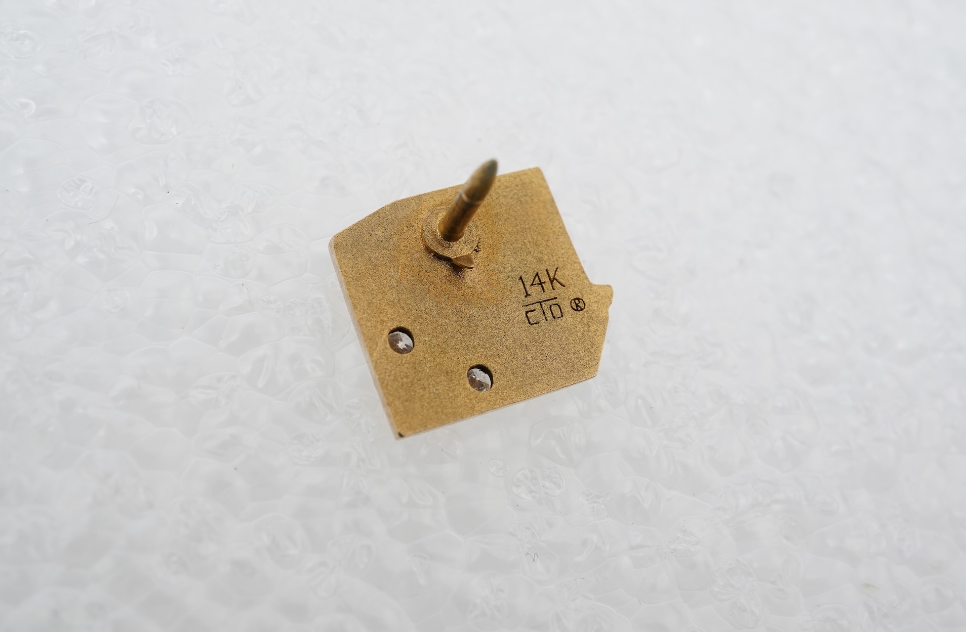 A gold and diamond novelty pin